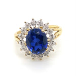 9CT YELLOW GOLD SYNTHETIC SAPPHIRE SURROUNDED BY DIAMONDS DRESS RING