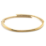 9CT YELLOW GOLD HINGED OVAL CROSS OVER PATTERNED BANGLE VALUED @ $3498