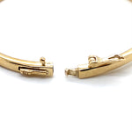 9CT YELLOW GOLD HINGED OVAL CROSS OVER PATTERNED BANGLE VALUED @ $3498