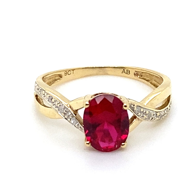 9CT YELLOW GOLD SYNTHETIC RUBY & DIAMONDS SET IN CROSSOVER PATTERN RING